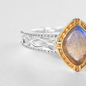 Macro detail of vintage S925 silver ring with hollow patterns and purple labradorite