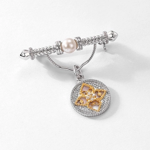 Vintage silver pearl brooch with twisted metal texture and gold flower medal pendant