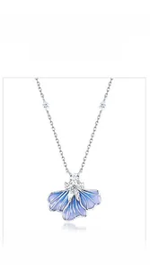 Detail view of blue enamel iris pendant with silver edges and white crystals on S925 necklace