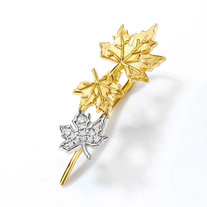Detail of S925 sterling silver maple leaf earrings with zircon inlay and gold plating