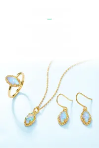 Macro detail of vintage opal jewelry set with gold floral relief and colorful gems
