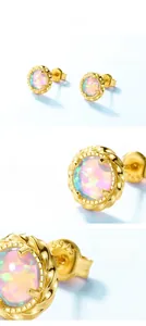 Macro shot of S925 sterling silver stamp and opal inlay on gold plated twisted earrings