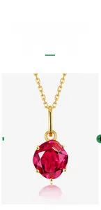 Macro detail of 925 sterling silver gold necklace featuring a ruby red corundum pendant