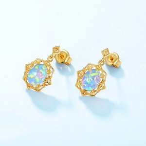 Vintage S925 silver opal stud earrings with gold hollow design on light blue background