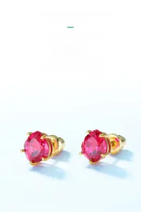 Macro detail of geometric red corundum earrings with four-prong gold plated setting