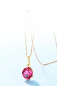 Detailed macro shot of a square-cut red corundum pendant on a fine gold chain