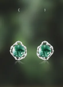 Macro detail of natural moss agate earrings showing translucent green plant-like textures