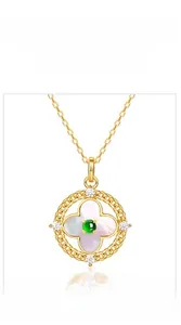 Detail of S925 silver gold-plated pendant with green jadeite and white mother of pearl