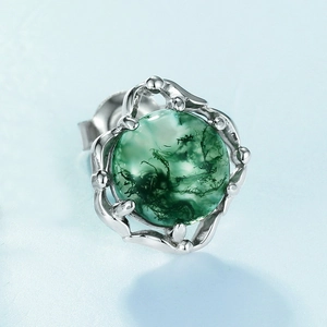 Macro detail of moss agate stud earring featuring green inclusions and silver vine setting