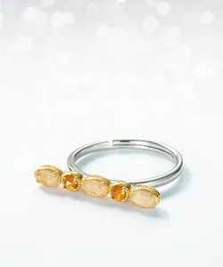 Detailed macro view of horizontal bar ring with Rutilated Quartz and Citrine gemstones