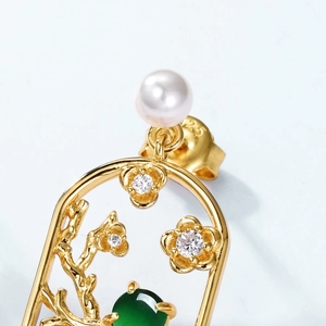 Macro detail of S925 silver gold plated plum blossom earring with green jade and pearl