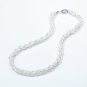 Elegant multi-strand twisted pearl necklace with polished silver circular clasp on white
