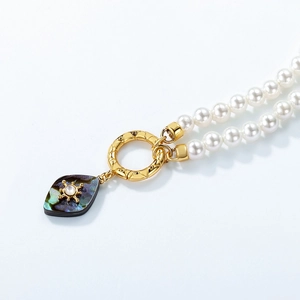 Double-strand pearl necklace with abalone shell leaf pendant and golden accents