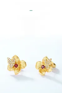 Detail of 925 silver 10K gold plated butterfly flower earrings with garnet and zircon