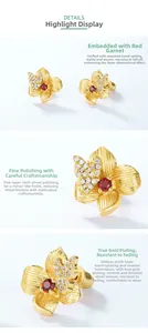 Macro detail of 925 silver flower earrings featuring garnet center and crystal butterfly