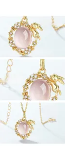 Macro detail of S925 silver bunny necklace featuring natural rose quartz and gold plating