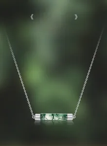 Macro shot of natural moss agate cylinder pendant on a delicate S925 silver chain