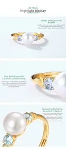 Macro shot of S925 sterling silver gold-plated ring with natural pearl and blue topaz