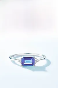 Macro detail of rectangle-cut alexandrite ring with zircon accents in 925 silver