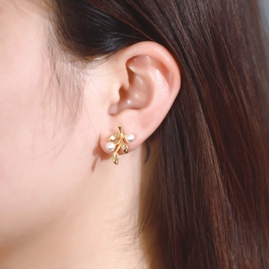 Elegant gold leaf branch earrings with white pearls on a model, S925 sterling silver style