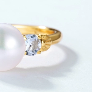 Macro shot of S925 gold-plated ring showing elegant pearl and sparkling gemstone details