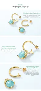 Macro view of dolphin tail earrings with amazonite inlay and gold plating details