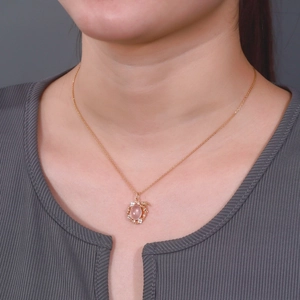 Rose gold necklace with oval pink quartz bunny pendant and zircon pavé on model