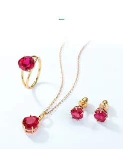 Detail of red corundum jewelry set with gold ring, necklace and stud earrings