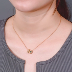 Cute bear pendant necklace with dark green gemstone on a rose gold chain for women