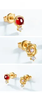 Detailed close-up of S925 sterling silver garnet rose earrings with gold plating and engraving