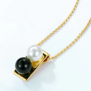 Elegant S925 sterling silver necklace with gold pendant featuring white pearl and black onyx