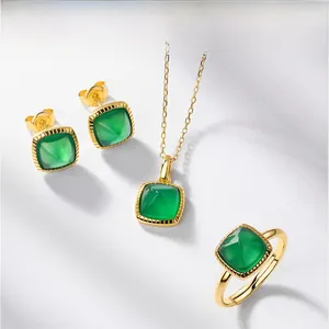 Macro detail of gold-plated geometric green agate earrings, necklace and ring jewelry set