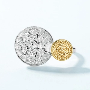 Vintage relief coin ring in silver and gold duo-tone with baroque crest engraving