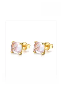 Detailed macro view of gold-plated 925 silver ear studs with pink cushion-cut crystals