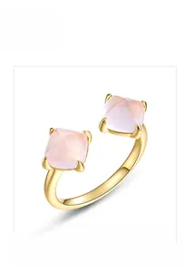 Detail of s925 silver adjustable open ring with square pink crystal stones in gold finish