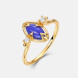 Detail of S925 silver gold-plated ring with oval lapis lazuli stone and zircon accents