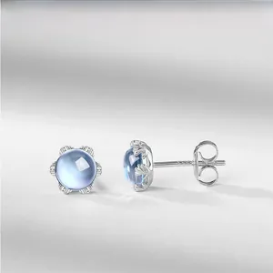 Détail de boucles d'oreilles en argent S925 avec topaze et gravure délicate de pétales