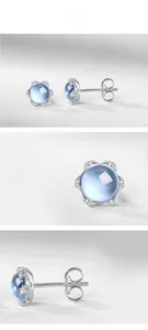 Vues détaillées des boucles fleurs en argent S925 avec topaze bleue et plaqué or