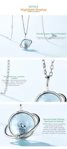Macro detail of planetary pendant featuring blue topaz and polished gold plating