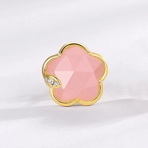 Macro view of pink flower stud earring featuring faceted crystal and gold plated petals