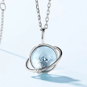 S925 silver planet pendant necklace with sky blue topaz on a light blue background