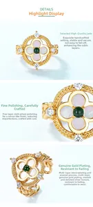 Detail of vintage flower ring with green jadeite center and white shell petals