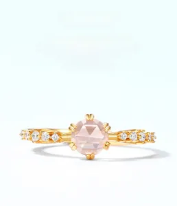 Close-up of S925 sterling silver gold plated ring with pink quartz and side stones