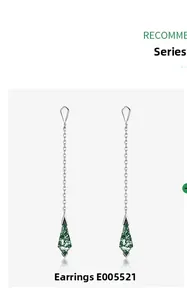 Detail of long silver drop earrings with kite-shaped green moss agate stone pendants