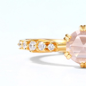 Macro detail of gold plated silver ring with rose cut pink stone and pave set zircons