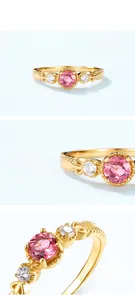 Macro detail of S925 silver gold-plated ring with red tourmaline and zircon stones