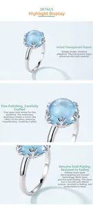 Detail of S925 silver ring featuring sky blue topaz with snowflake prong setting