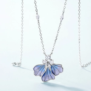 Macro detail of enamel iris flower pendant with sparkling white zircons on silver chain