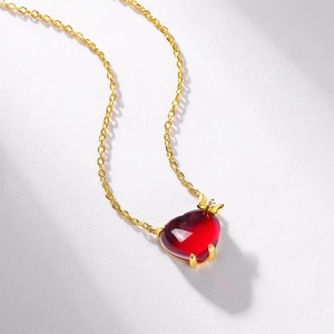Elegant gold S925 silver necklace featuring a red heart ruby and dainty bow pendant