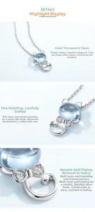 Macro detail of cat necklace with sky blue topaz stone and polished silver finish